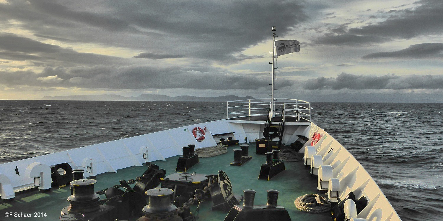 Horizonte 166.jpg - approaching Cape Horn from the Antarctic Peninsulaaboard of MS "Ushuaia". The ocean is very calm, not to comparewhen we headed south 10 days before. The weather may change veryfast within the Drake Passage between Tierra del Fuego and theAntarctic Continent and stormy seas with huge waves are common.   click here for Google Maps View   Position: S55°20'36" W66°11'07", at sea level Camera: Panasonic TZ41, date: 02/02/2014, 21:05 local time
