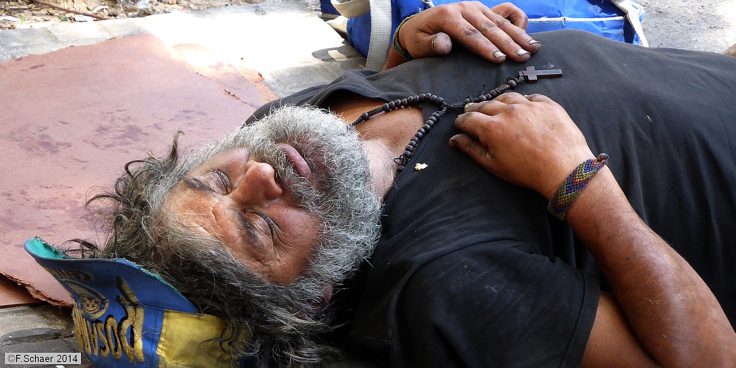 Horizonte 203.jpg - an obvious catholic tramp take a nap on a quiet corneralong a sidewalk in the Boca-quarter in Buenos Aires, Argentina.   click here for Google Maps View   Position: S34°38'00" W58°21'40", elev.13m/40ft Camera: Lumix TZ41, date: 10/01/2014, 11:42 local time