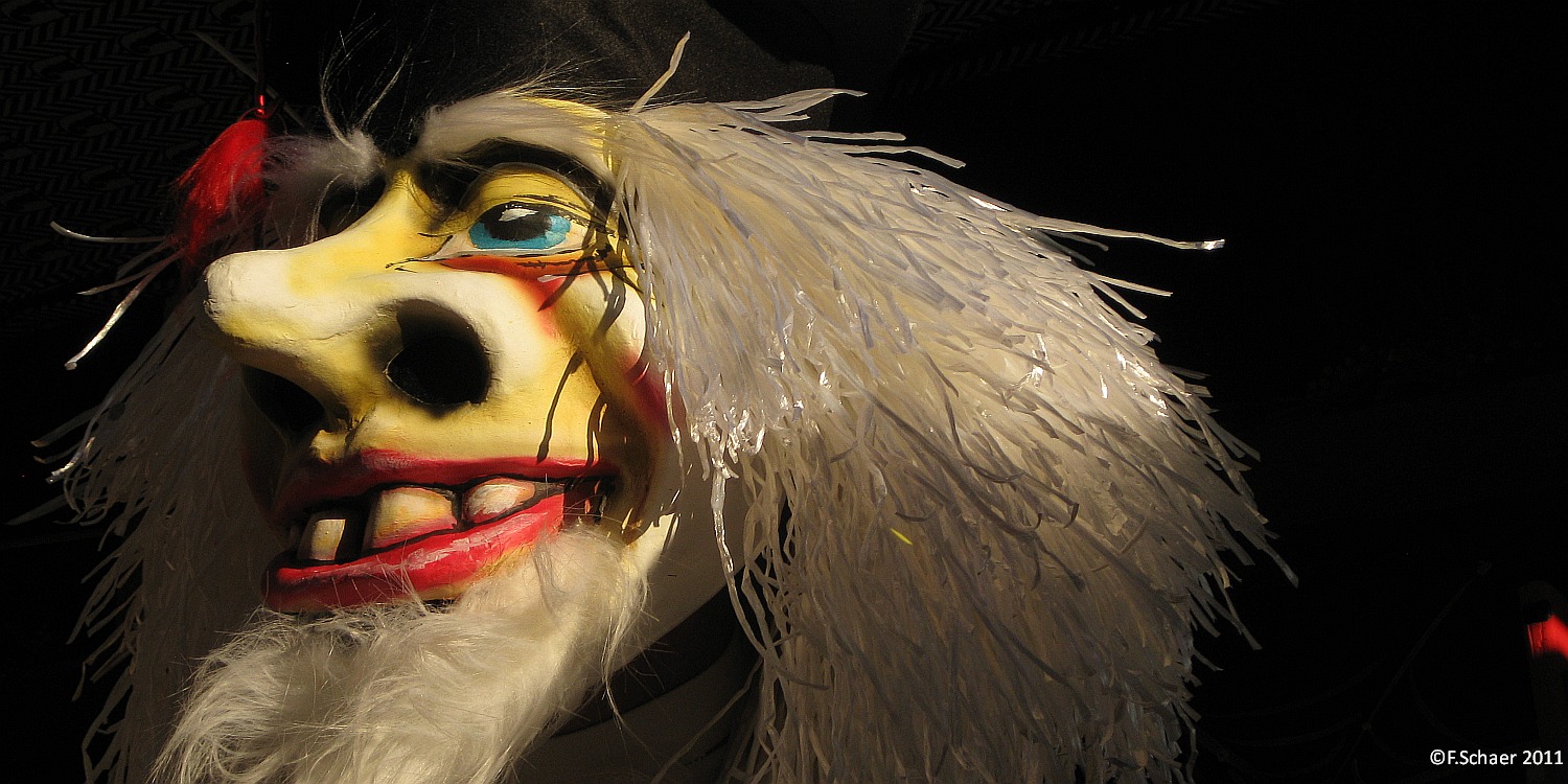 Horizonte 245.jpg - a mystic lonely mask in a narrow lane at the "Basler Fasnacht",(carnival in Basel, Switzerland). This traditional event exists since more than800 years and is based of the catholic rite Lent. Today more than 12'000 maskedstake part on this 72-hour event together with some 150'000 visitors....   click here for Google Maps View   Position (Google Earth): N47°33'37,50"/E07°35'26,45" elev. 246m/810ft Camera: Canon Ixus 80IS, date: 14/03/2011, 11:32 local time