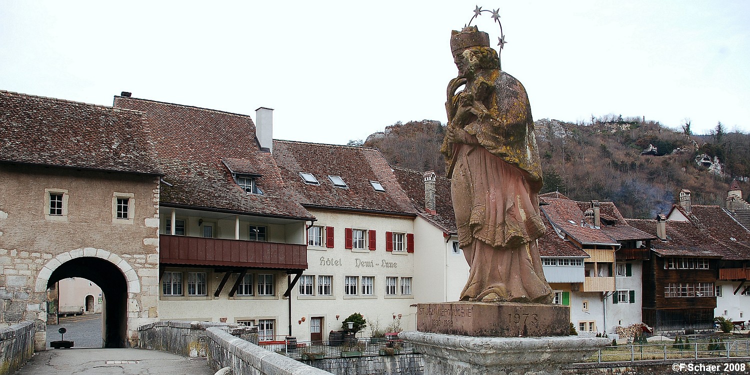 Horizonte 261.jpg - shows the riverfront of the medevial village of St.Ursanne in thenorthwest of Switzerland. The statue in the middle of the bridge represents the "Saints of the Bridges", Johannes Nepomuk (1345-1392),living in Prague.   click here for Google Maps View   Position (Google Earth): N47°21'50,60"/E 07°09'17", elev.435m/1415ft Camera: Nikon D50, with 28mm PC-Nikkor, date: 09/03/2008